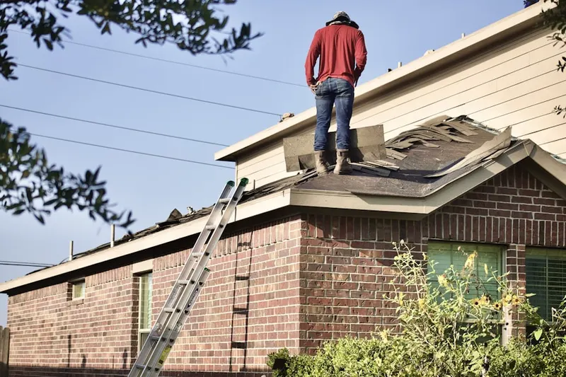 Professional roofer working on a residential roof in Interquest